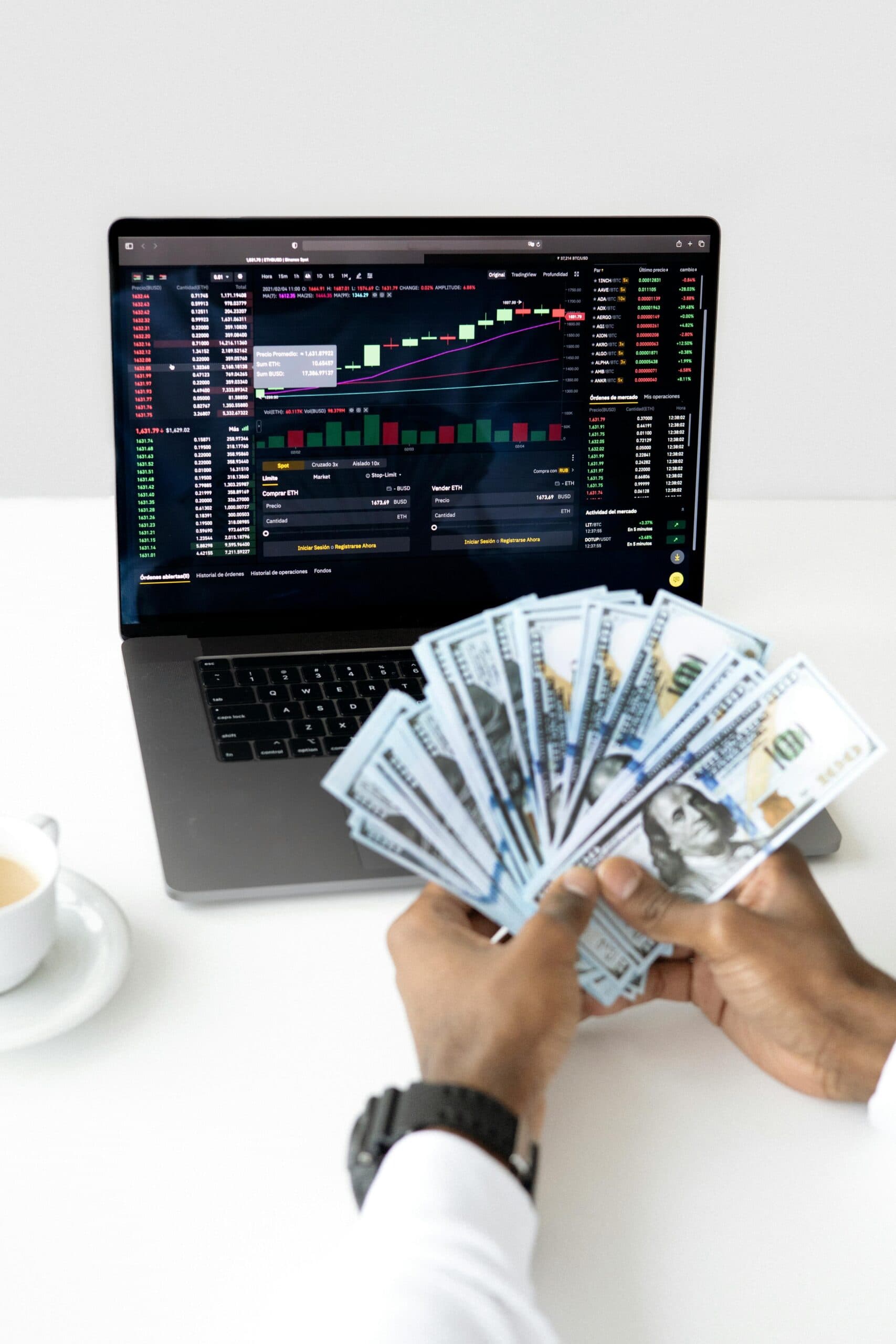 Incentive marketing programs featured image hand holding dollar bills in front of laptop
